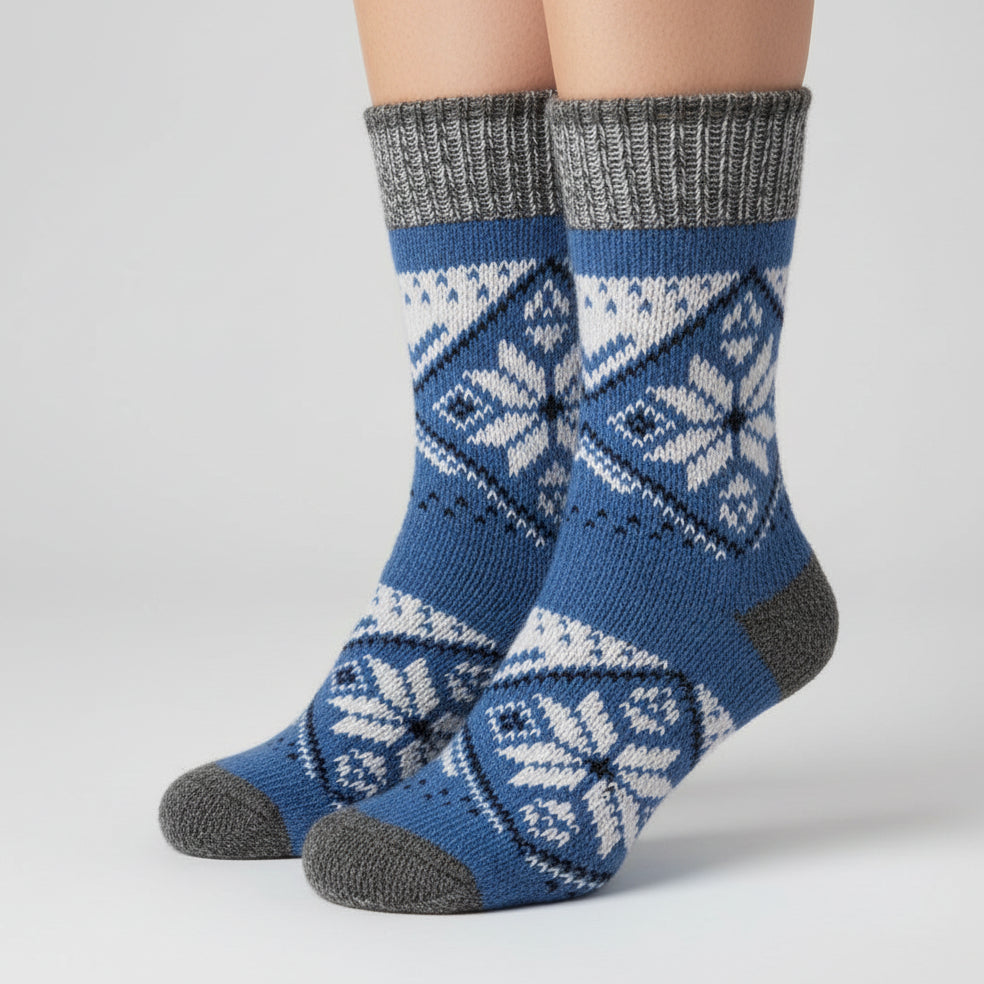 Blue and gray knitted sock with a pattern on a white background