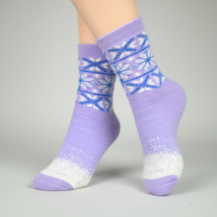 Purple socks with a blue and white pattern worn by a person on a gray background