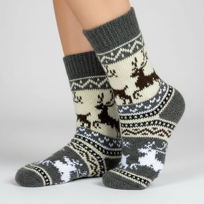 Knitted sock with reindeer design on a white background